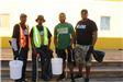 Four men pose together during the clean up event